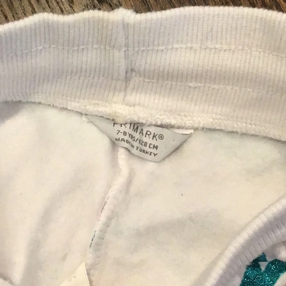 PRIMARK -children's tracksuit featuring a colorful all-over graffiti-style print